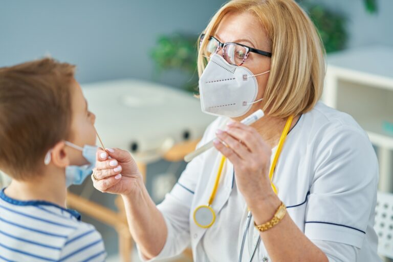 Pediatrician doctor examining little kids in clinic